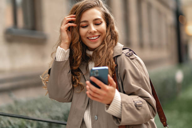 istock Young woman using mobile device standing in the city 1440242961