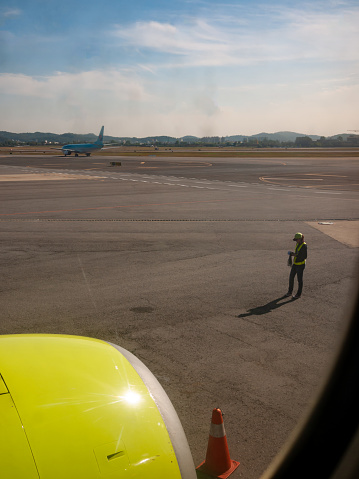 Gimpo, South Korea - October, 2012: a avation mechanic is standing on the taxiway
