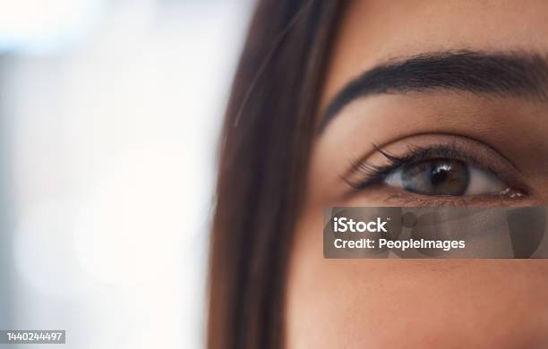 Closeup Portrait Of A Mixed Race Unrecognizable Woman Eye With Perfect Eyebrows And Natural Looking Eyelash Extensions While At Home On The Weekend Stock Photo - Download Image Now