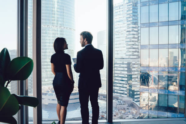 istock Confident colleagues talking about business project in office 1440245036
