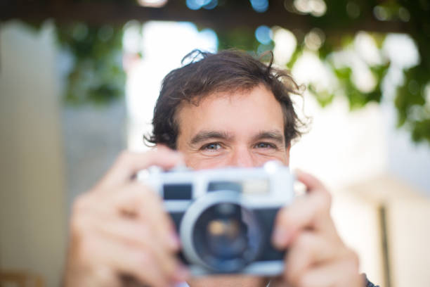 istock Close-up of Caucasian man resting with camera 1440245283