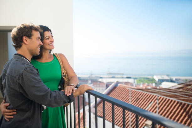 istock Side view of young multiethnic couple resting on balcony 1440245365