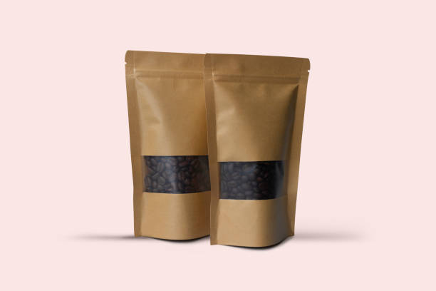 istock Two blank brown Kraft paper bag with coffee beans in transparent window on white background. Packaging template mockup collection with clipping path 1440245552