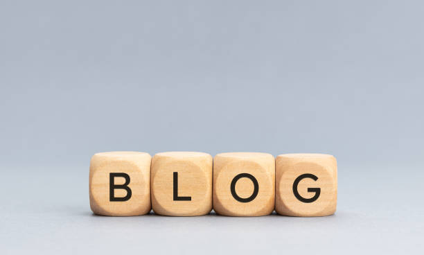 blog palabra sobre bloques cúbicos de madera sobre fondo gris - bloguear fotografías e imágenes de stock