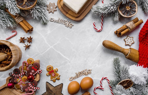 istock Happy New Year 2023. Banner with kitchen utensils, Christmas decorations, cinnamon, gingerbread and spruce on a marble background. A greeting card for Christmas. The concept of cafes and restaurants. 1440253673