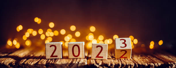 Wooden cubes changing calendar date from 2022 to 2023. New year coming concept stock photo