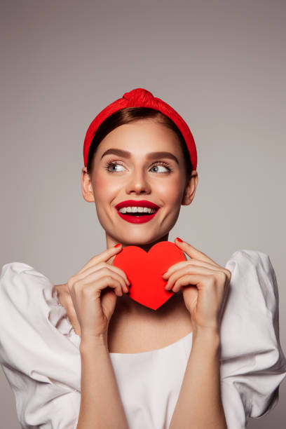istock Beautiful emotional woman holding present box 1440254677
