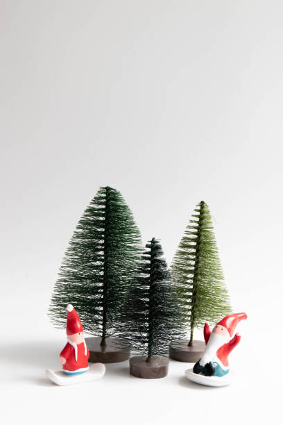 istock Little Green Pine Trees and Santa Clause on white back ground 1440254740