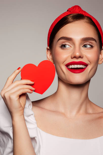 istock Beautiful emotional woman holding present box 1440254773