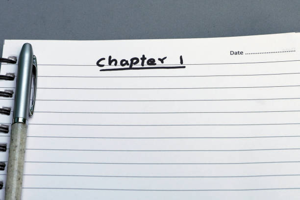 istock White notebook with text CHAPTER 1 written and a pen lying in the empty paper. 1440255987