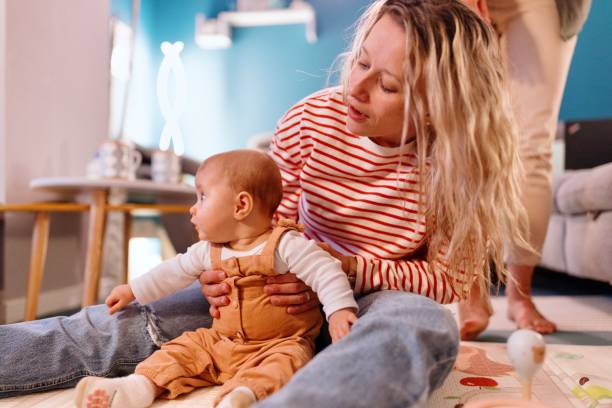istock Happy young lesbians playing with baby 1440256056