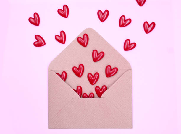 istock Envelope and red hearts on pink background. Valentine's day, love, anniversary concept. 1440256801