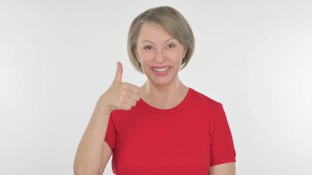 istock Thumbs Up by Old Woman on White Background 1440256926