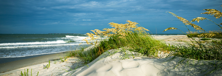 Sand dunes on the beach on the cloudy day. Fort Macon State Park. Bogue Banks. North Carolina.USA. Image for banner or web header.