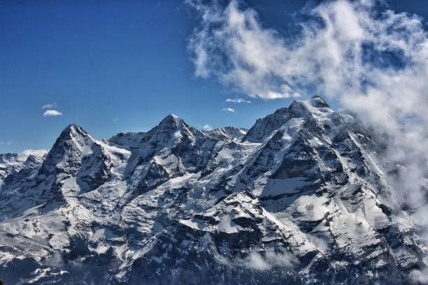 Free Stock Photo of Snowy mountain range under a blue sky with light ...