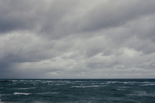 Beautiful shot of the sea with grey dark cloudy sky