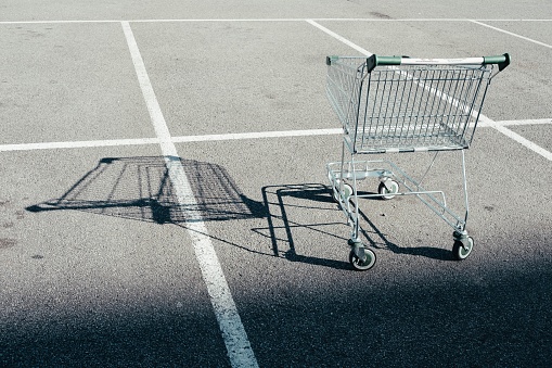 A single shopping cart in the parking lot