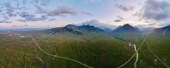 A panoramic shot of a beautiful landscape with valleys, mountains, and rivers