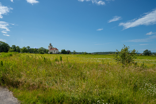 Kungälv, Sweden - July 15 2022: Small church by an open field.
