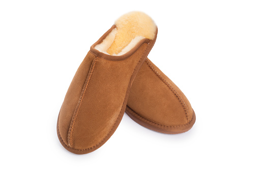 Studio shot of sheepskin carpet slippers cut out against a white background