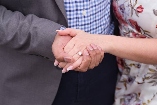 istock Engaged couple holding hands with engagement ring 1440263997