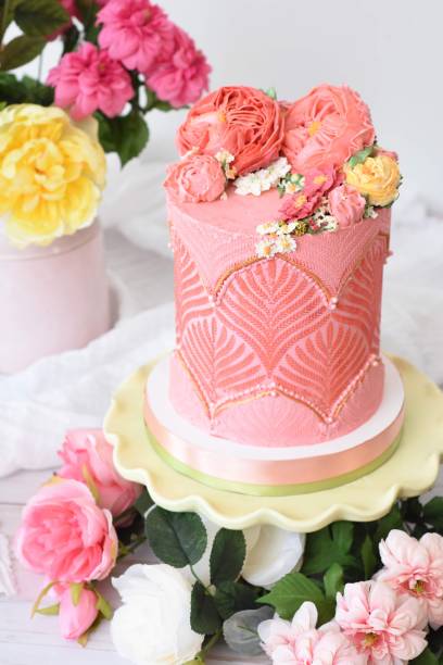 Beautifully decorated flower cake dessert with flowers around and white background