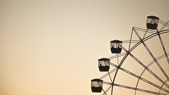 A wide shot of a Ferris wheel on the right with space for text on the left