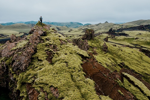 An aerial view of a man on the mountaintop of the Iceland Moss Landscape in Katla Geopark