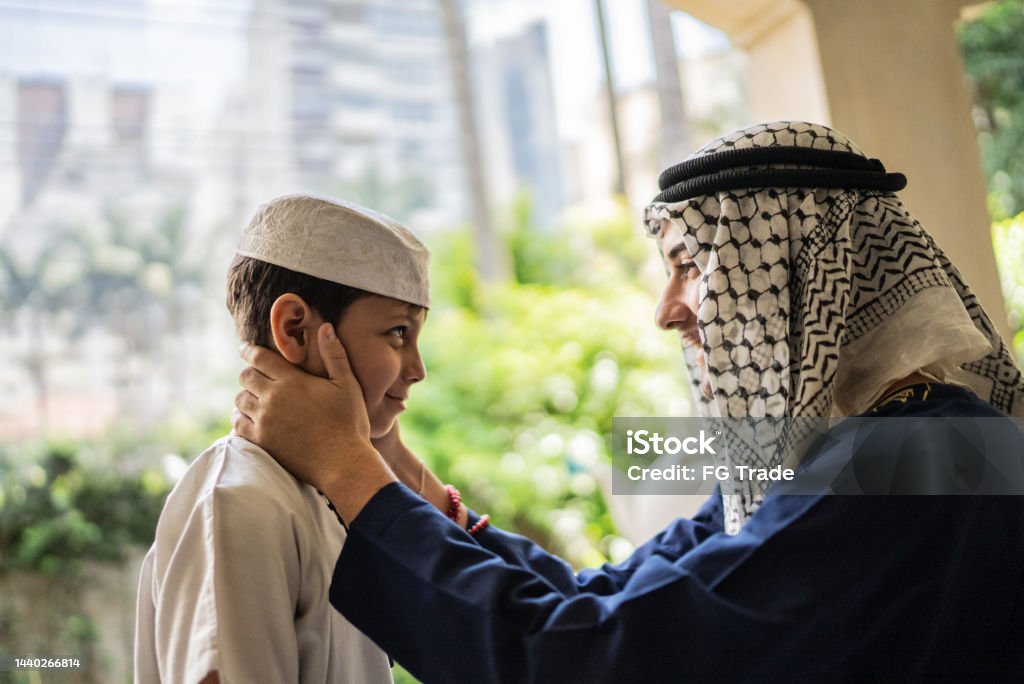 Proud young man talking to younger brother in the balcony 10-11 Years Stock Photo
