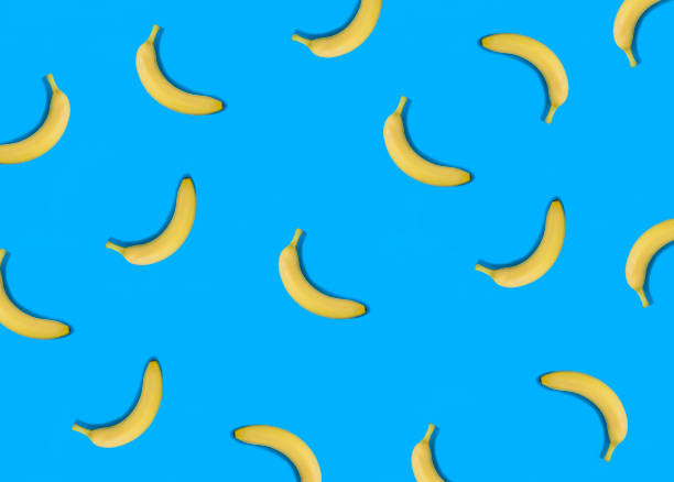 istock Banana on the blue background. Flat lay. Pattern. Top view. 1440267267