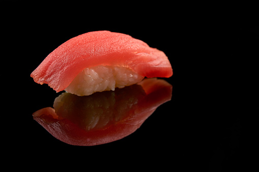 Isolated sushi closeup with reflection and black background