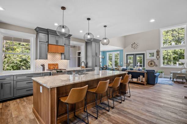 Interior design of a beautiful kitchen with a large island in a modern new England colonial home The interior design of a beautiful kitchen with a large island in a modern new England colonial home house interiors stock pictures, royalty-free photos & images