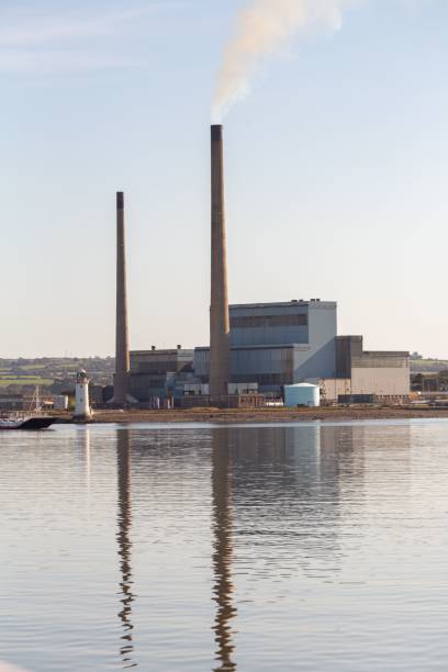 istock Factory building with its reflection in the water 1440270980