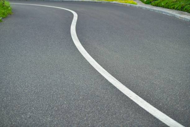 istock White line diving the asphalt road 1440271519