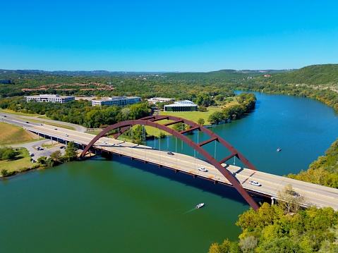 The cars driving on Pennybacker Bridge over the lake in Austin, Texas