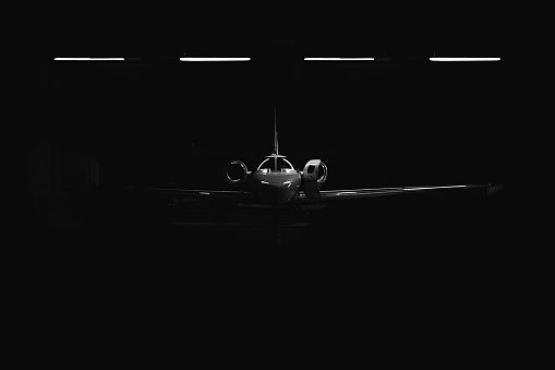 A front of a light airplane in the bunker with lights