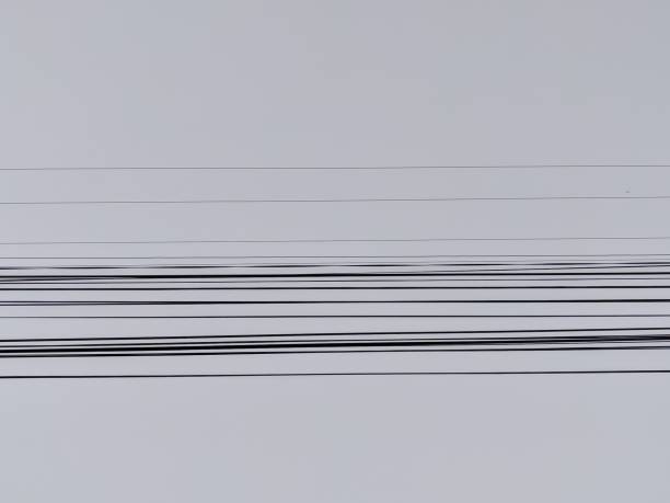 The electrical wires with the blue sky in the background