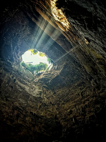 A beautiful cave with sunlight coming through the entrance