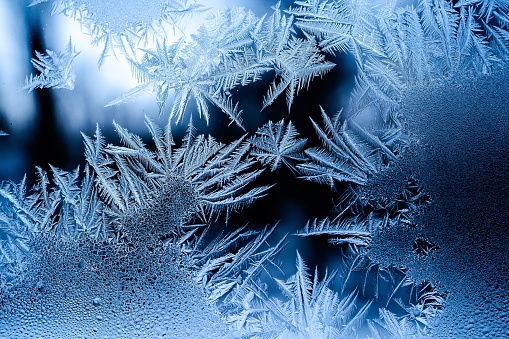 Snow and ice crystals on a metal surface.