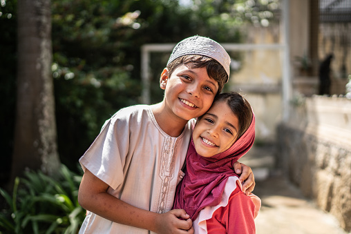 Portrait of happy islamic siblings