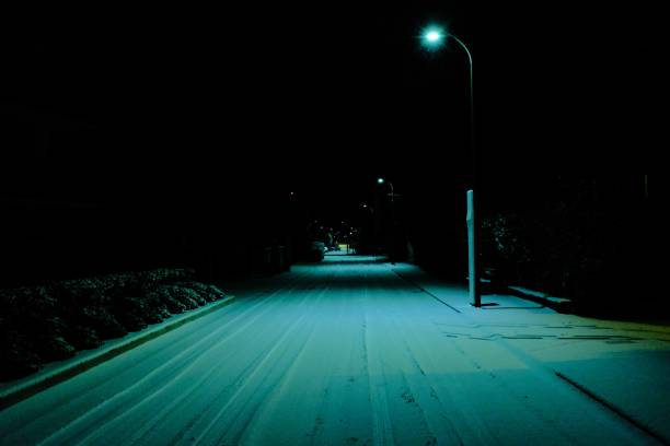 istock A dimly lit road with a street lamp 1440272579