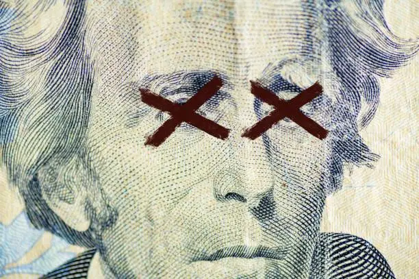 Photo of Closeup shot of the Andrew Jackson, on the dollar bill with x painted over its eyes