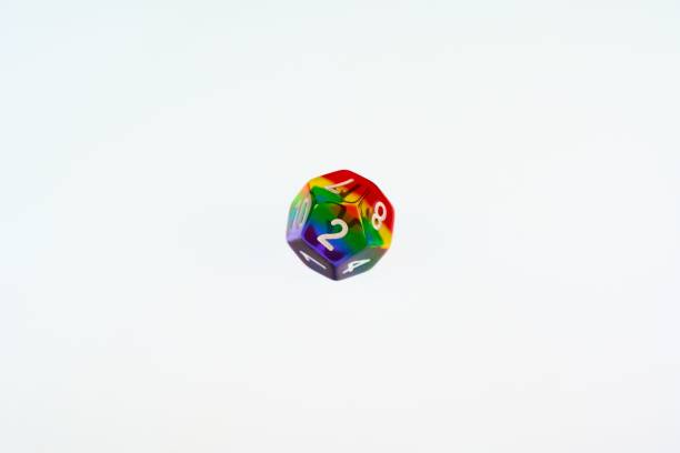 A D12 rainbow die showing the concept of LGBTQ representation and inclusion in tabletop RPG gaming A D12 is a twelve sided die used for RPG games which have recently seen an increase in representation and inclusion of diverse players developing 8 stock pictures, royalty-free photos & images