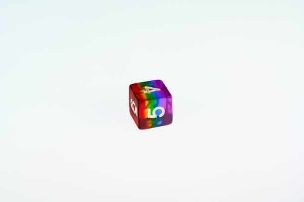 A D6 rainbow die showing the concept of LGBTQ representation and inclusion in tabletop RPG gaming A D6 is a six sided die used for RPG games which have recently seen an increase in representation and inclusion of diverse players developing 8 stock pictures, royalty-free photos & images