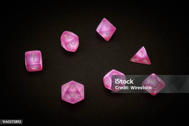 A Standard Set Of 7 Dice In Pink For Rpg Games Stock Photo - Download Image Now - Dice, Fantasy, Chance