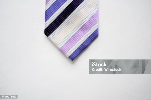 Overhead Shot Of A Striped Tie On A White Surface Stock Photo - Download Image Now - Necktie, Tying, Silk