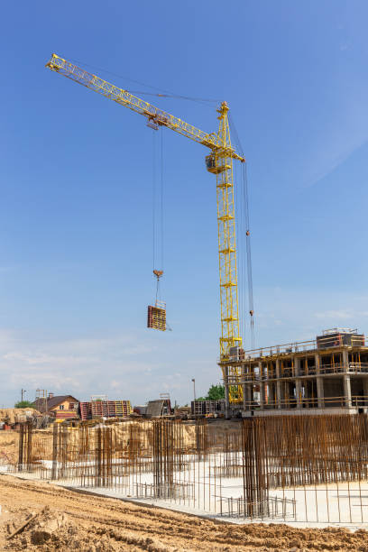 istock Crane and building construction site against blue sky. 1440273507