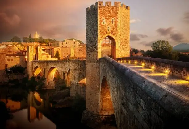 The famous Romanesque Bridge in Besalú, Catalonia, Spain during sunset