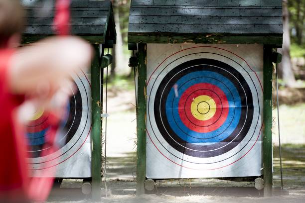 istock Selective focus shot of a target with a blurred person using bow and arrow 1440274744