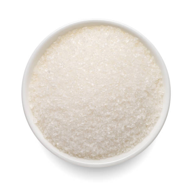 istock Crystal sugar in round bowl isolated on white. Top view. 1440274808